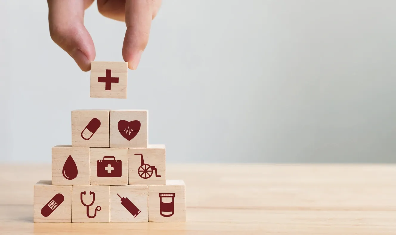 Wooden blocks with health icons stacked in a pyramid